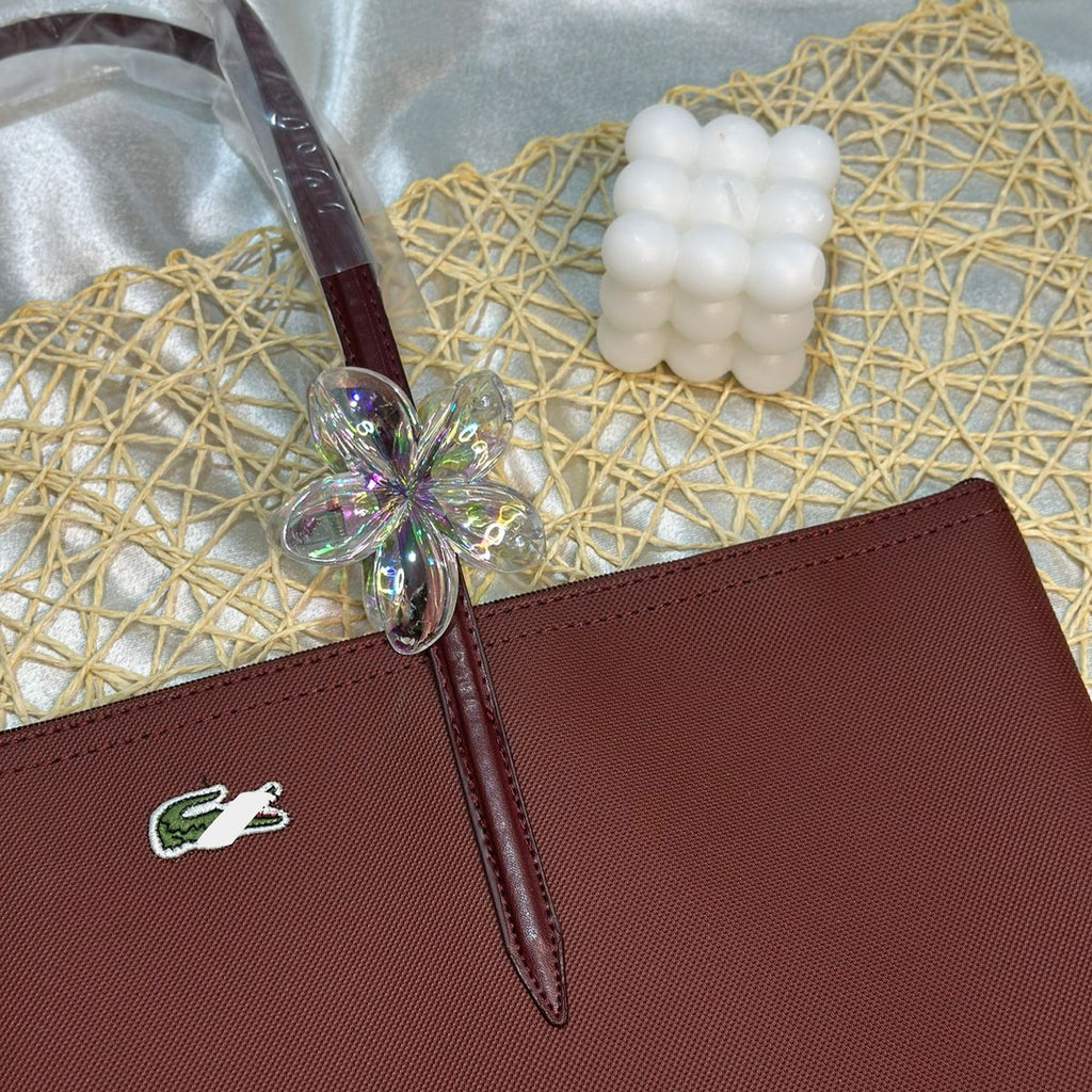 Brown handbag with a decorative handle on a textured surface